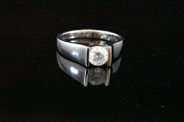 Silver ring with a solitaire diamond.