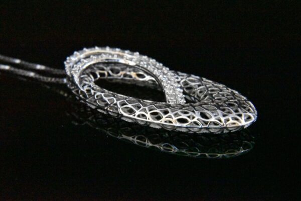 Silver filigree diamond pendant necklace.