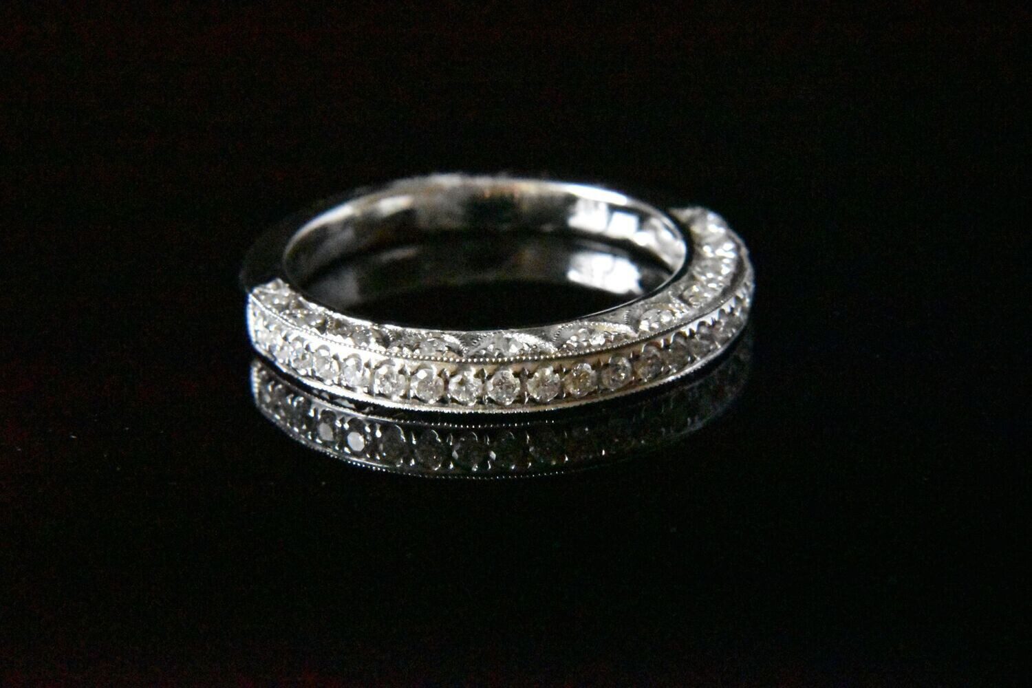 Diamond eternity band on black background.