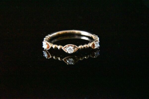 Rose gold diamond ring with three stones.