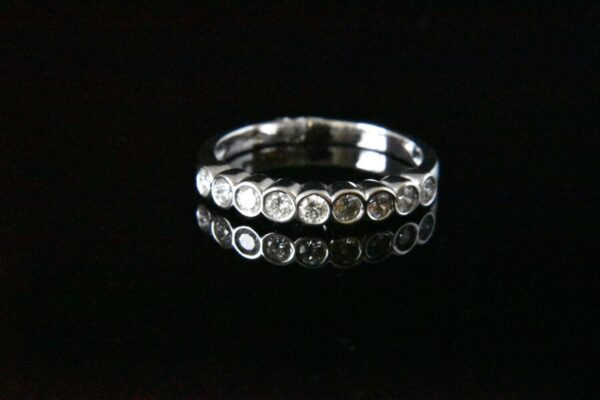 Silver ring with bezel-set diamonds.