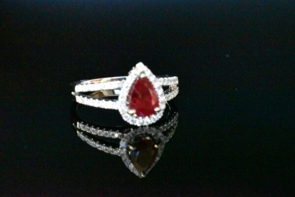 Pear ruby ring with diamond halo.