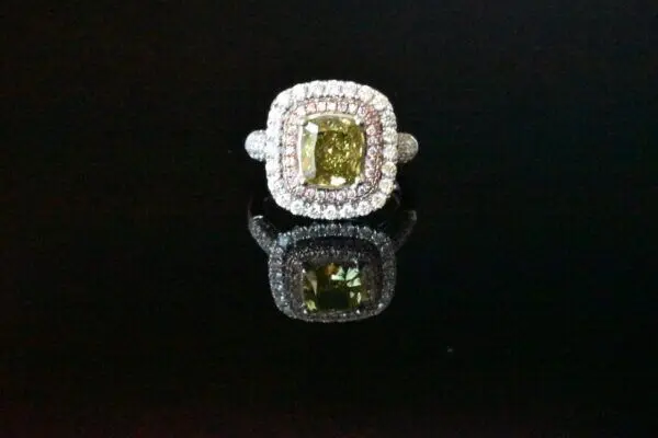 Double halo green diamond ring.