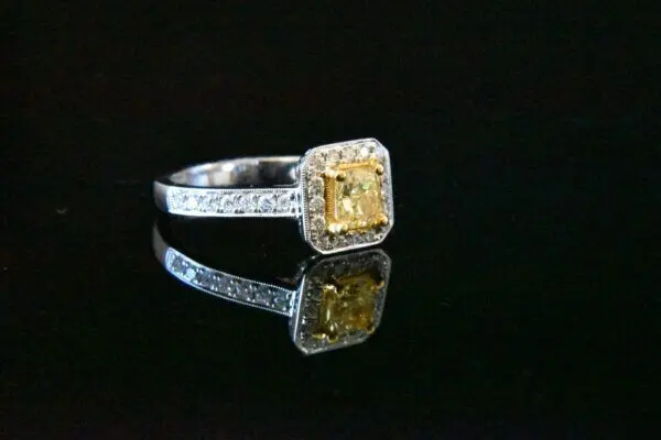 Yellow diamond ring with pave setting.