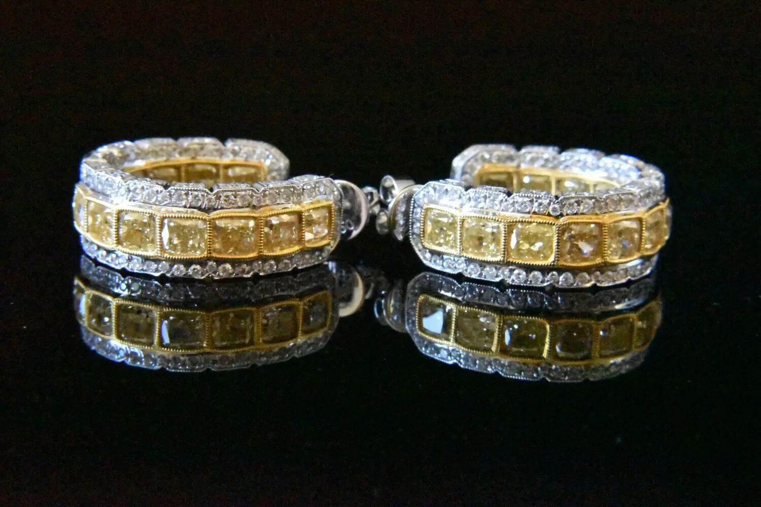 Diamond and yellow diamond hoop earrings.