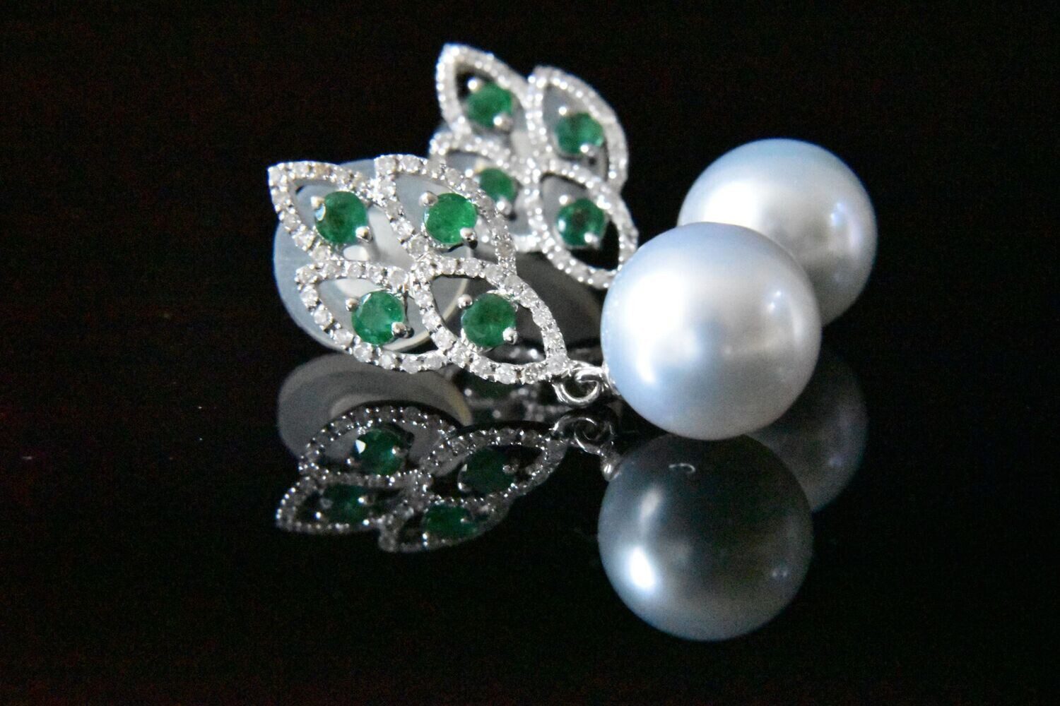 Elegant emerald and pearl earrings.