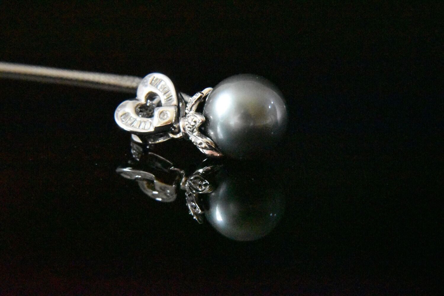 Black pearl pendant with heart charm.