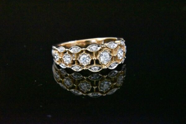 Gold diamond ring with ornate setting.