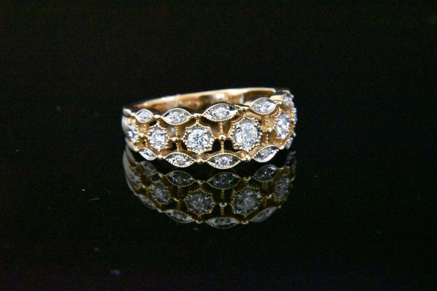 Gold diamond ring with ornate setting.