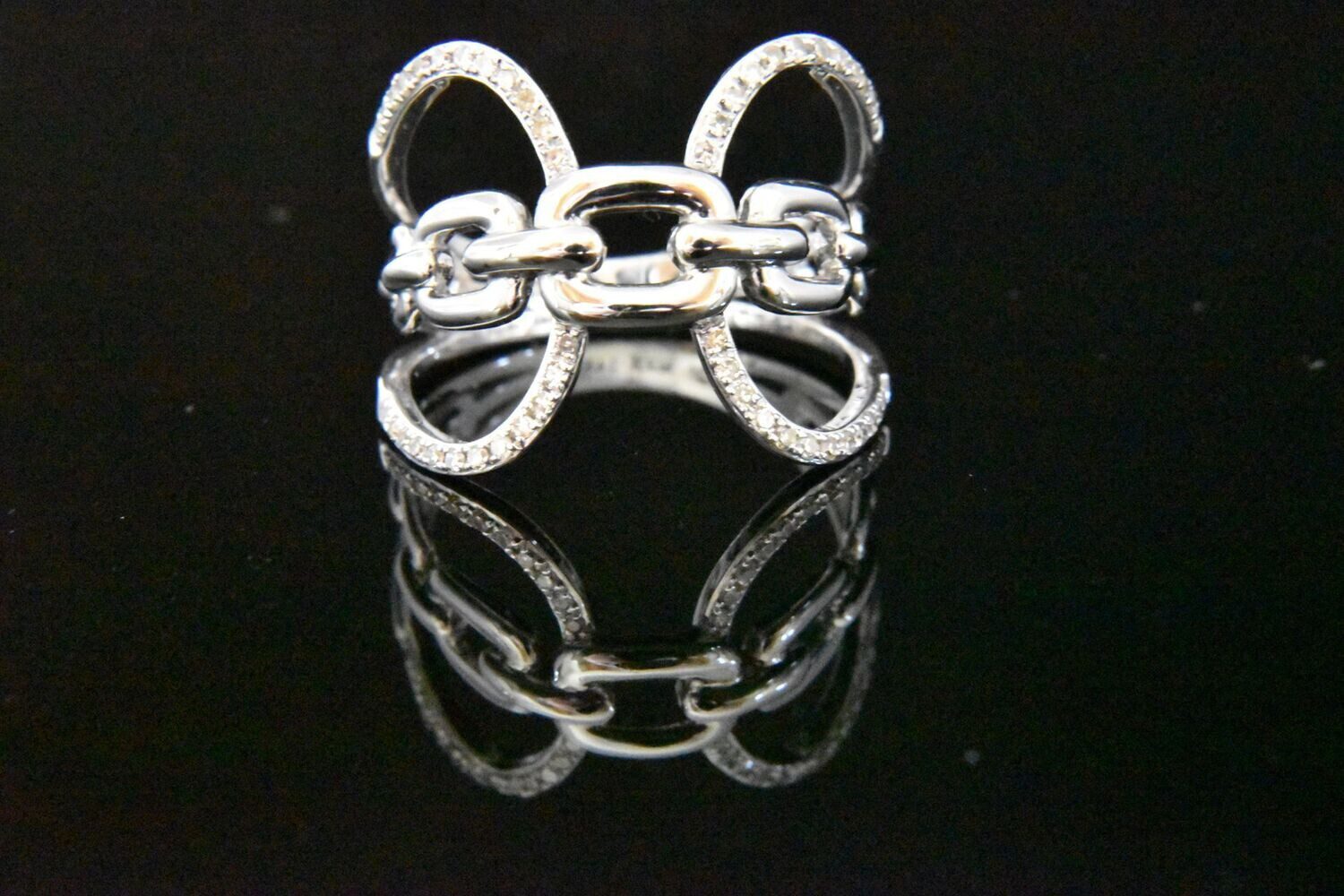 Silver chain ring with sparkling stones.