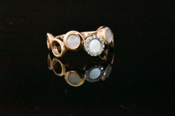 Rose gold ring with mother-of-pearl and diamonds.