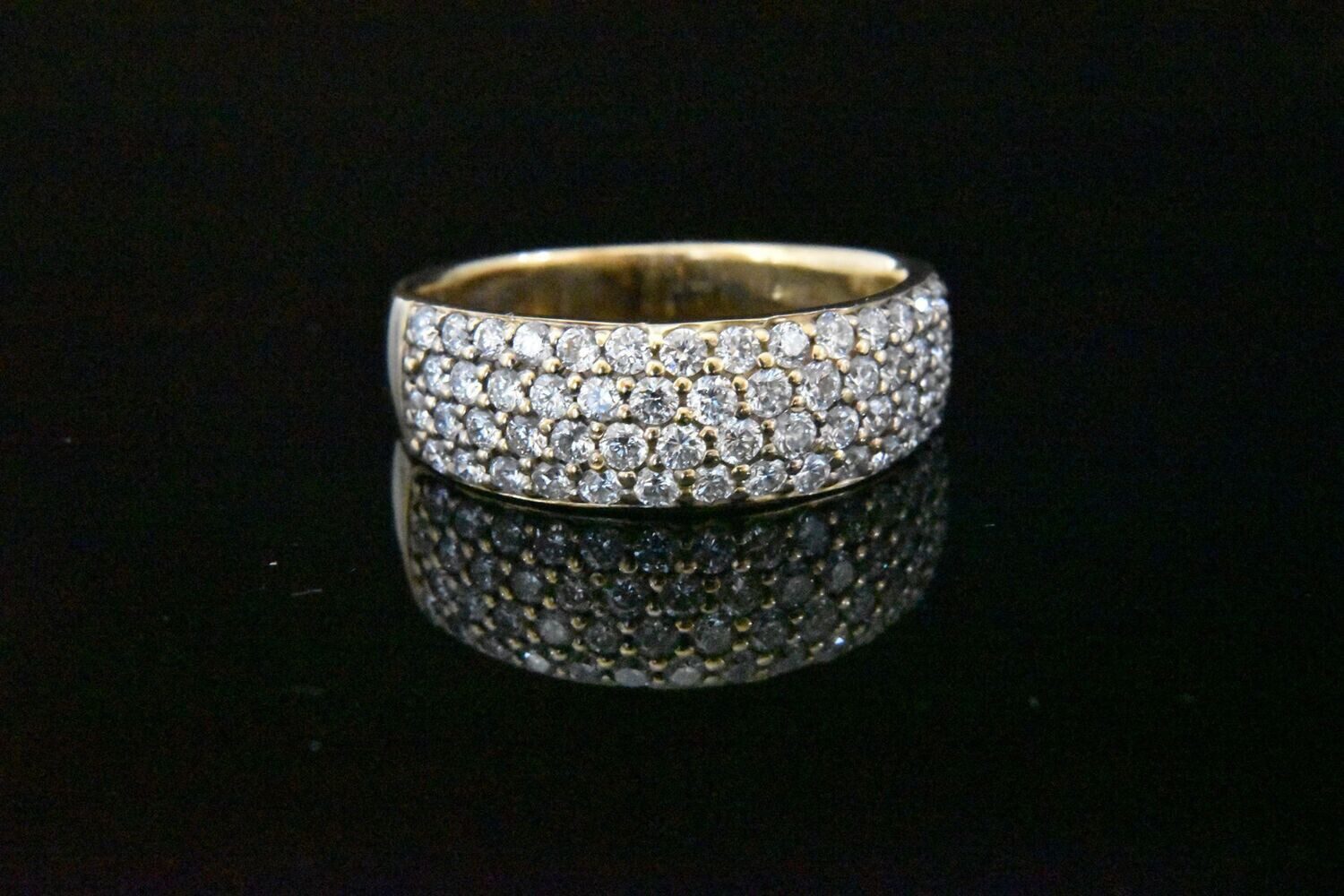 Gold band ring with pave diamonds.