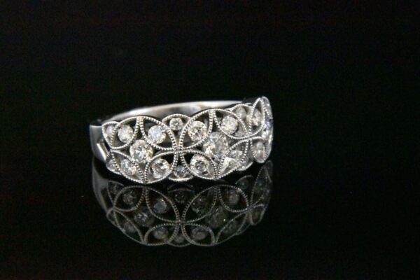 Diamond floral ring on black background.