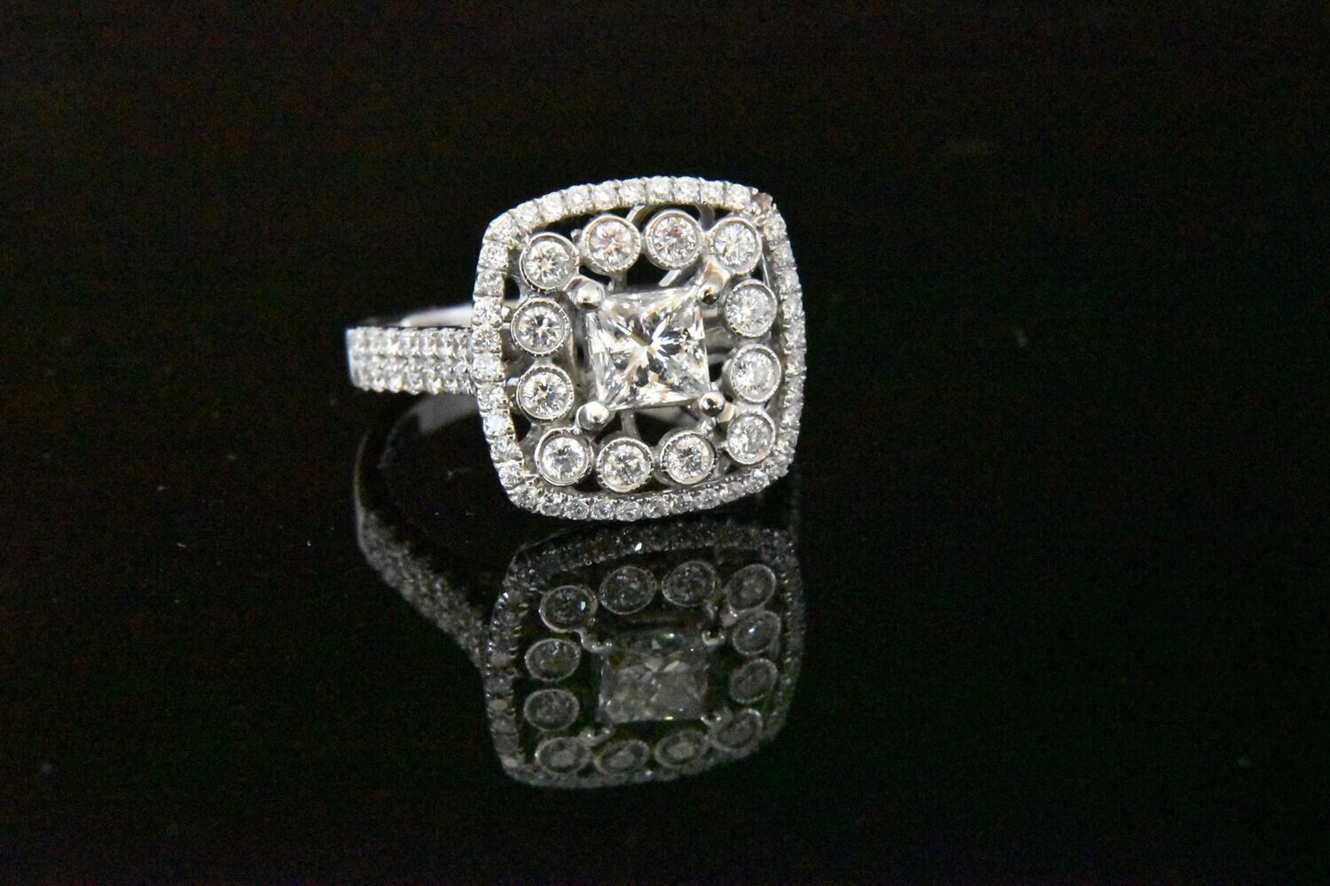 Diamond ring with halo and pave setting.