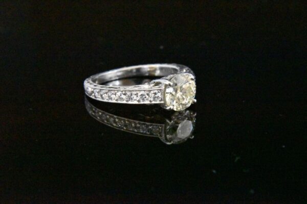 Diamond engagement ring with pave band.