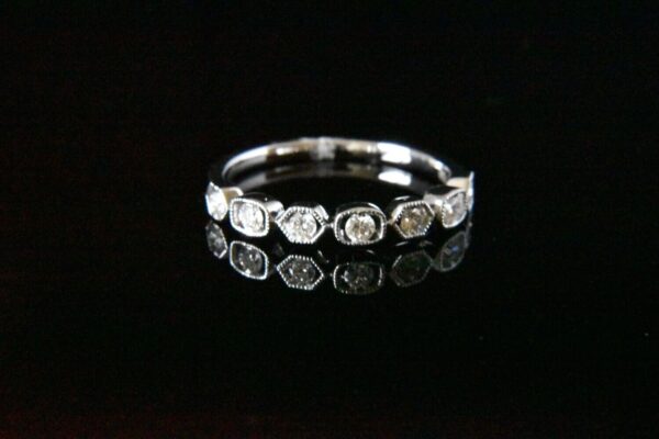 Diamond band ring with seven stones.