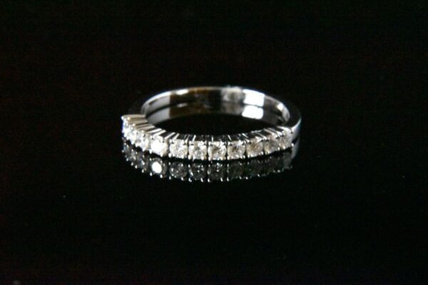 Diamond eternity band on black background.