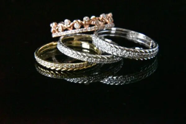 Three diamond rings; crown ring on top.