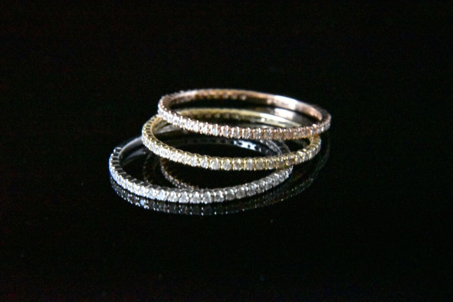 Three diamond eternity bands in gold.