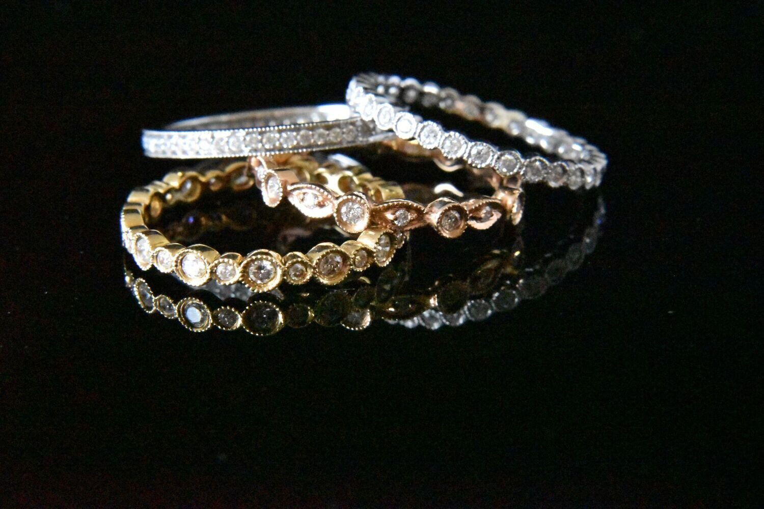 Three diamond eternity rings stacked.