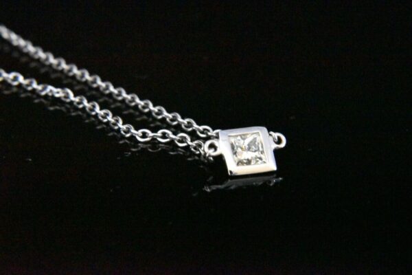 Diamond pendant on silver chain.