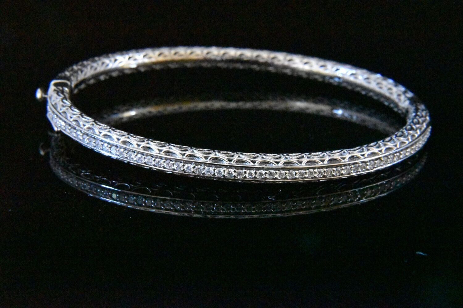 Silver filigree bangle with clear stones.