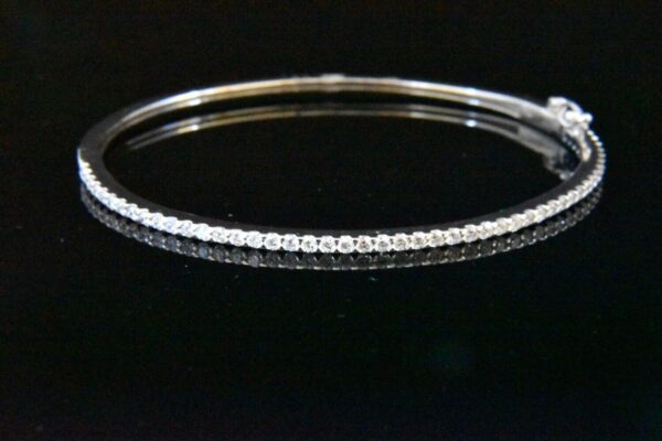 Silver bangle bracelet with diamonds.