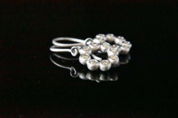 Silver earrings with sparkling stones.