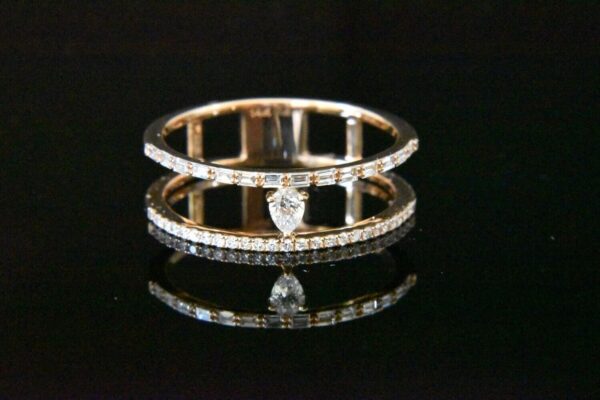 Double-band diamond ring with pear gemstone.