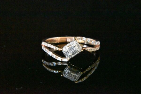 Diamond ring with emerald-cut center stone.