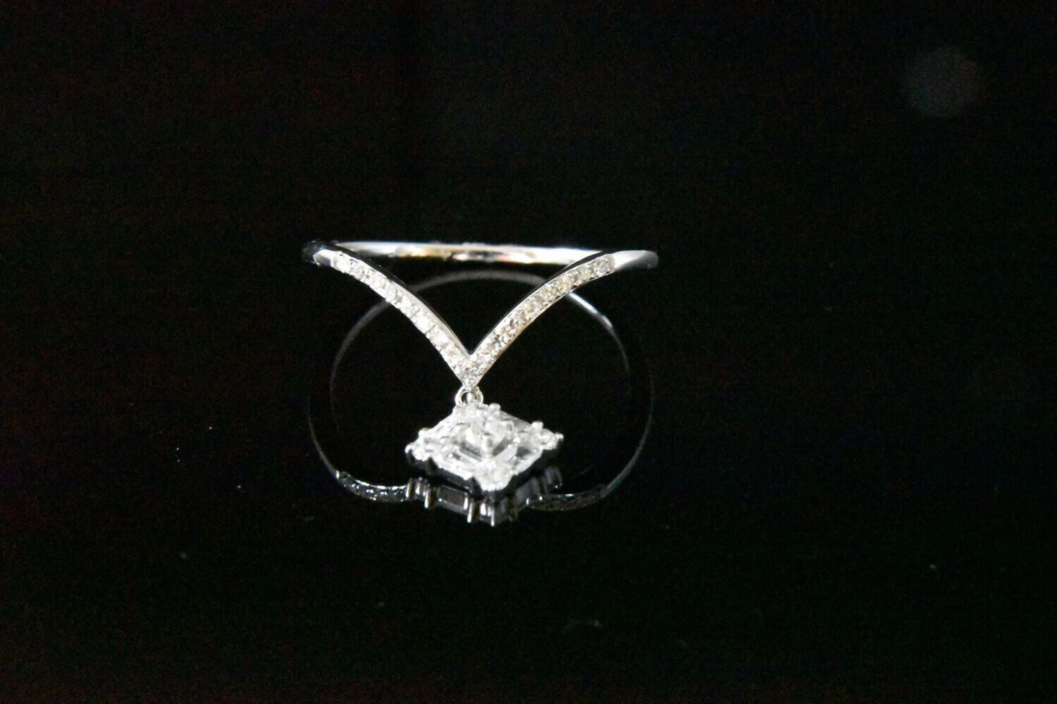 Diamond v-shaped ring with pendant.