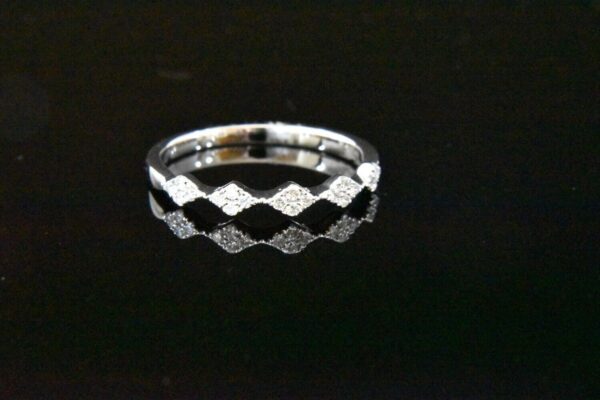 Diamond ring, wavy band, white gold.