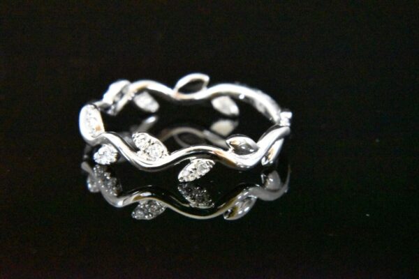 Diamond leaf ring on black background.