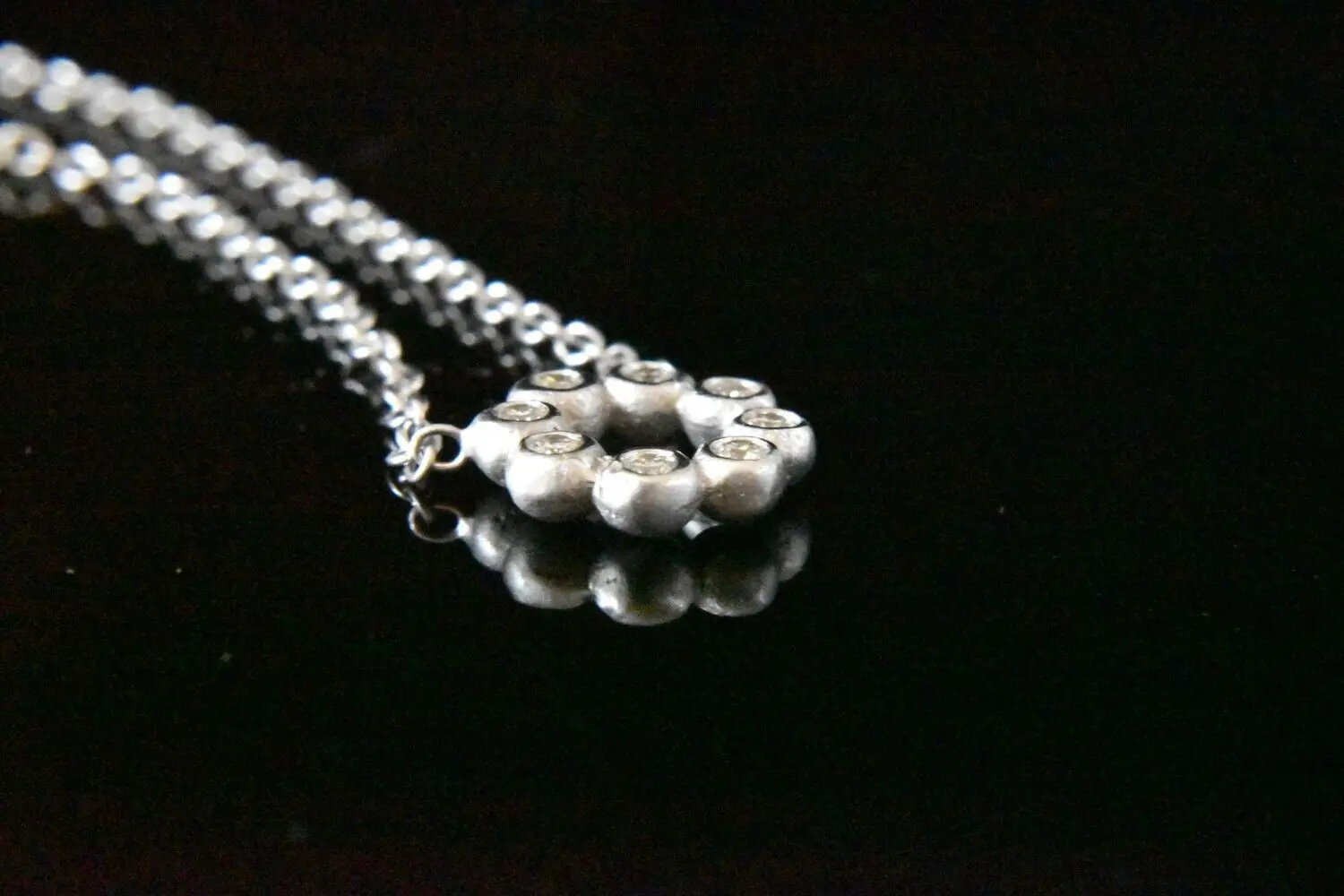 Silver necklace with small diamonds.