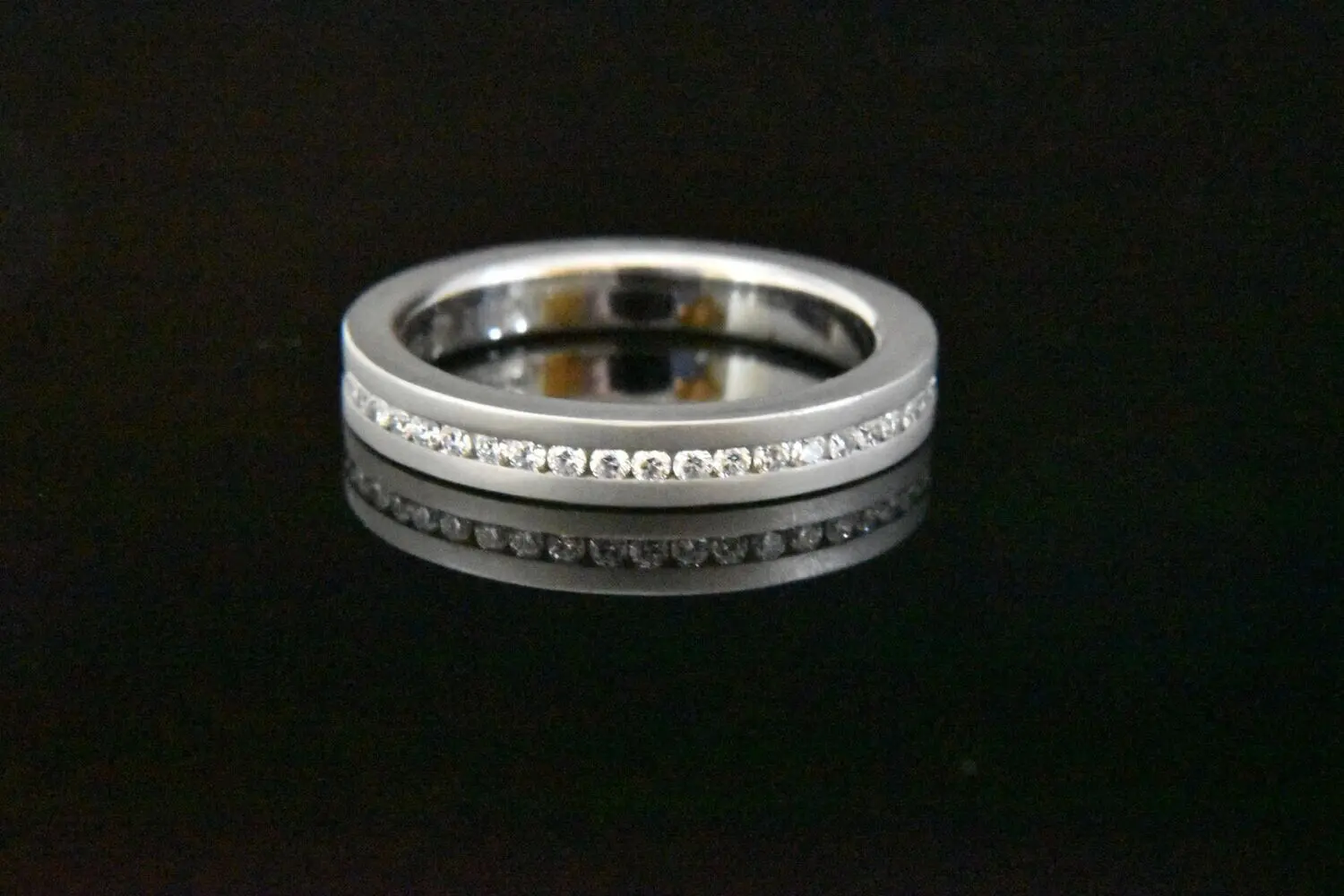 Silver diamond eternity band ring.