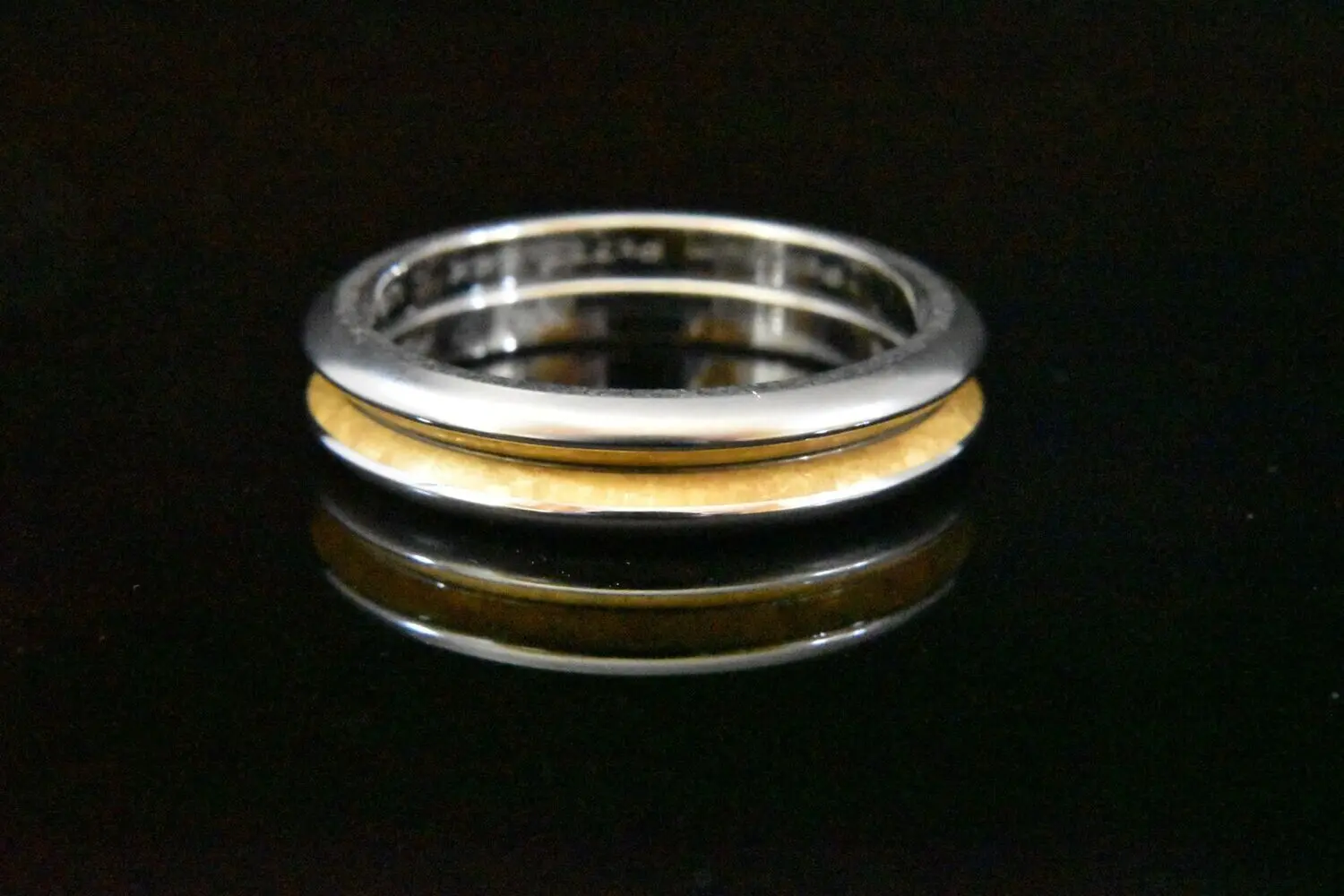 Here's an alt tag for the image: Two-toned metal ring with gold inlay.