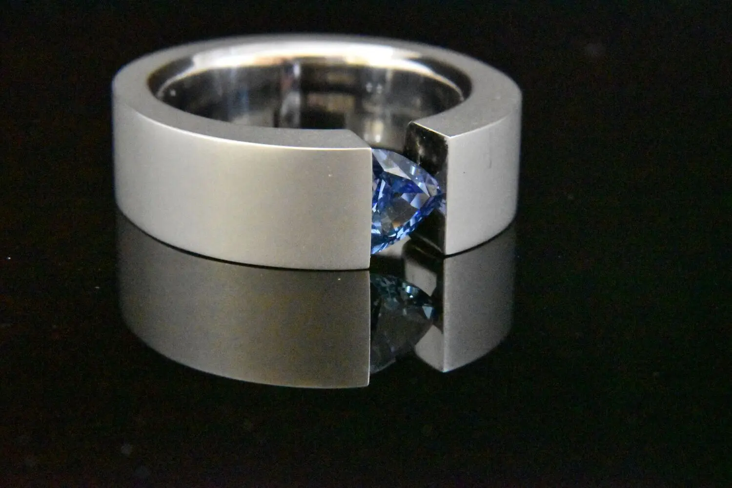 Silver ring with blue gemstone.