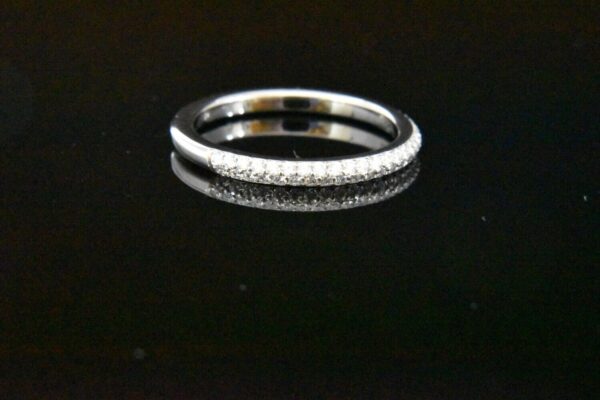 Diamond eternity band on black background.