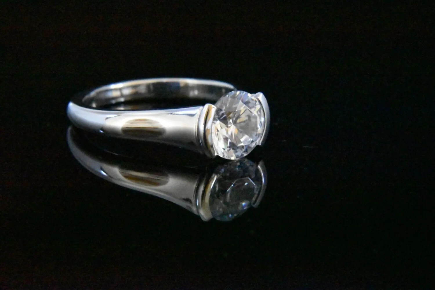 Silver ring with large clear gemstone.