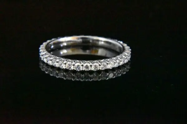 Diamond eternity band on black background.