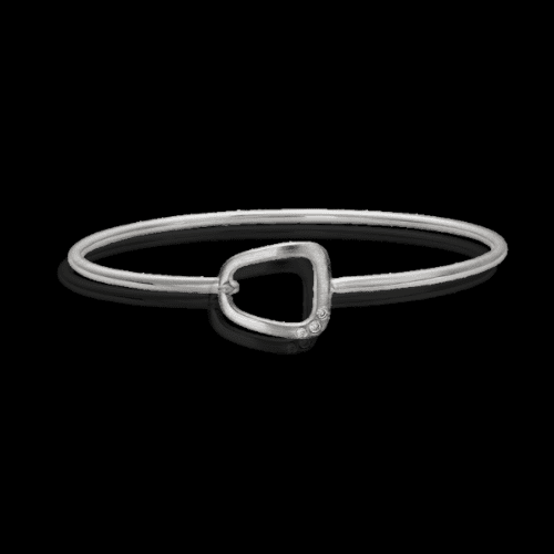 Silver bangle with diamond-set charm.