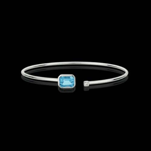 Here's an alt tag for the image: Blue topaz and diamond bangle bracelet.