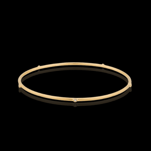 Gold bangle bracelet with diamonds.