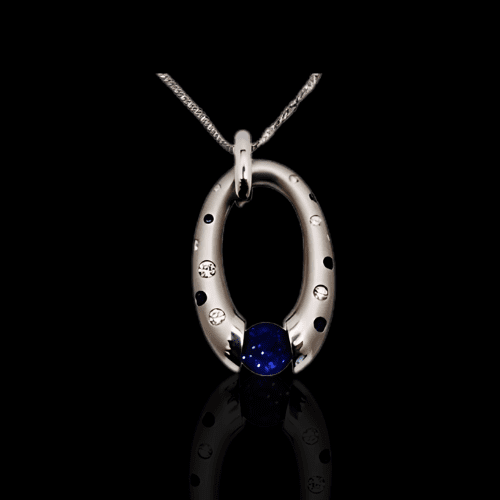 Oval sapphire pendant with diamonds.