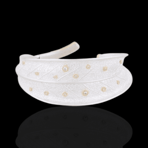 White leaf-shaped bracelet with diamonds.