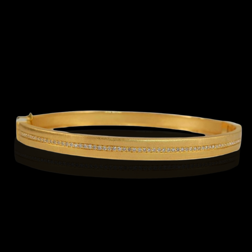 Gold bangle bracelet with diamond inlay.