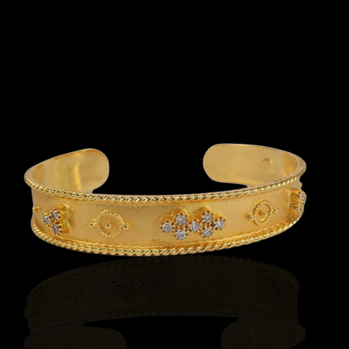 Gold cuff bracelet with diamond accents.