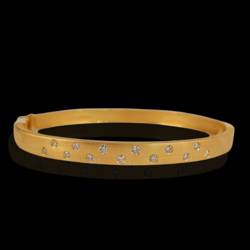 Gold bangle bracelet with diamonds.