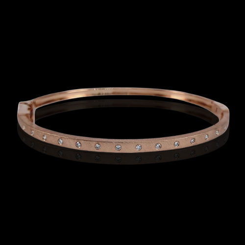 Rose gold bangle with diamond accents.