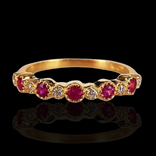 Gold ruby and diamond band ring.